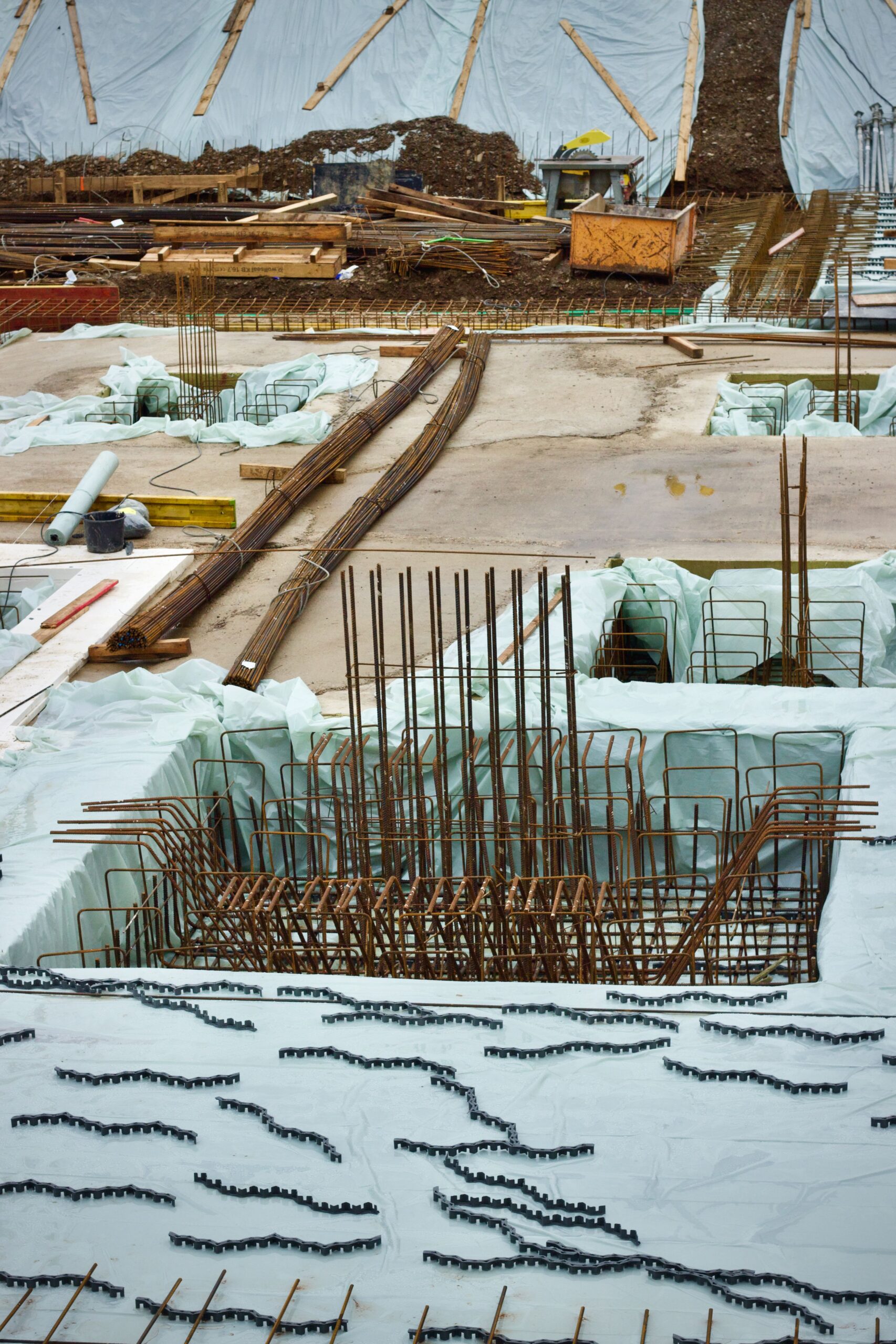 A detailed view of a commercial building foundation under construction with steel rebar reinforcement.